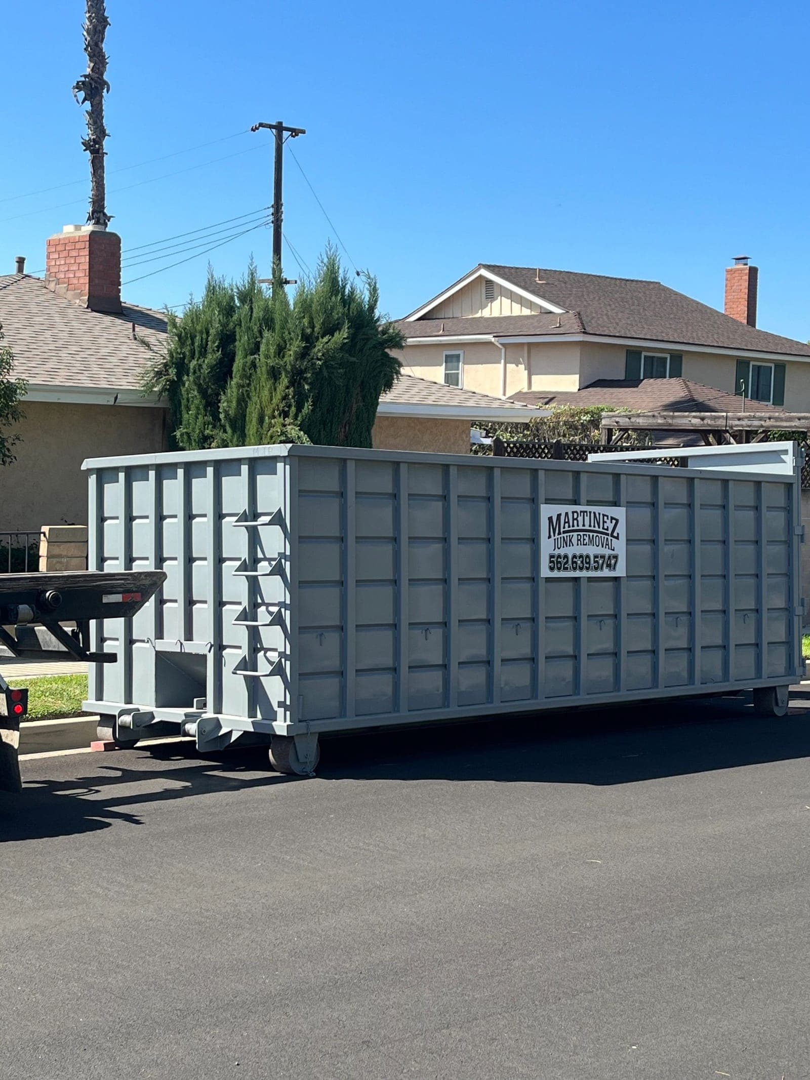 A Martinez Junk Removal roll-off dumpster on delivery day